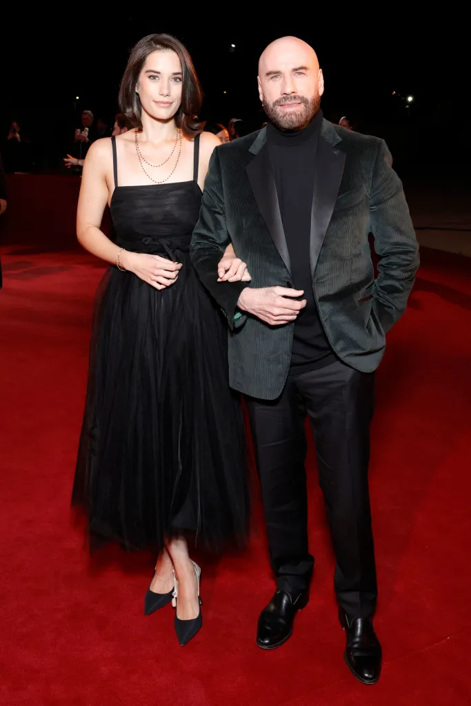 Ella Bleu Travolta and John Travolta on a red carpet.