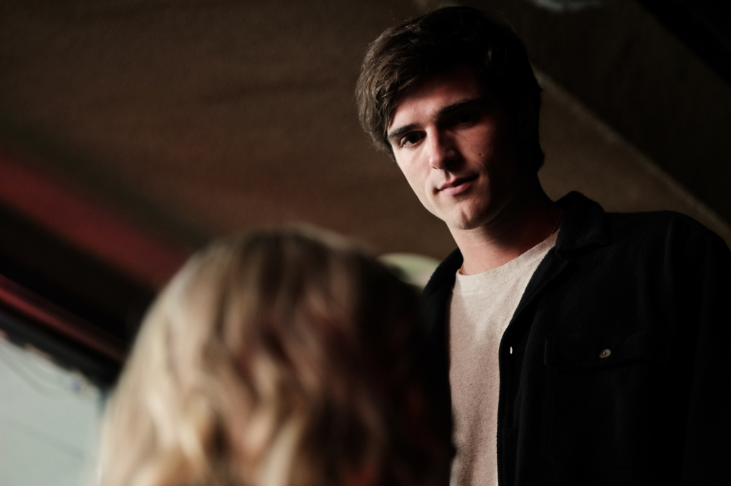 Jacob Elordi from Euphoria season 2, episode 1, looking at someone with a subtle smirk.