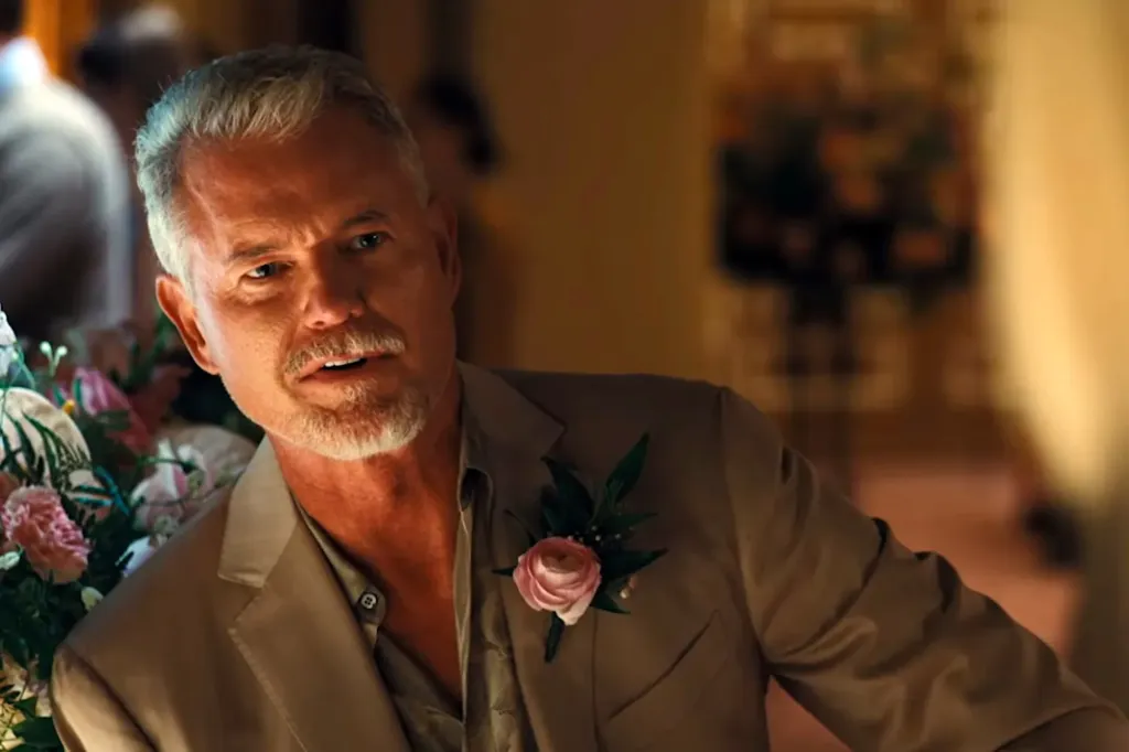 Eric Dane in a beige suit jacket with a pink boutonnière.