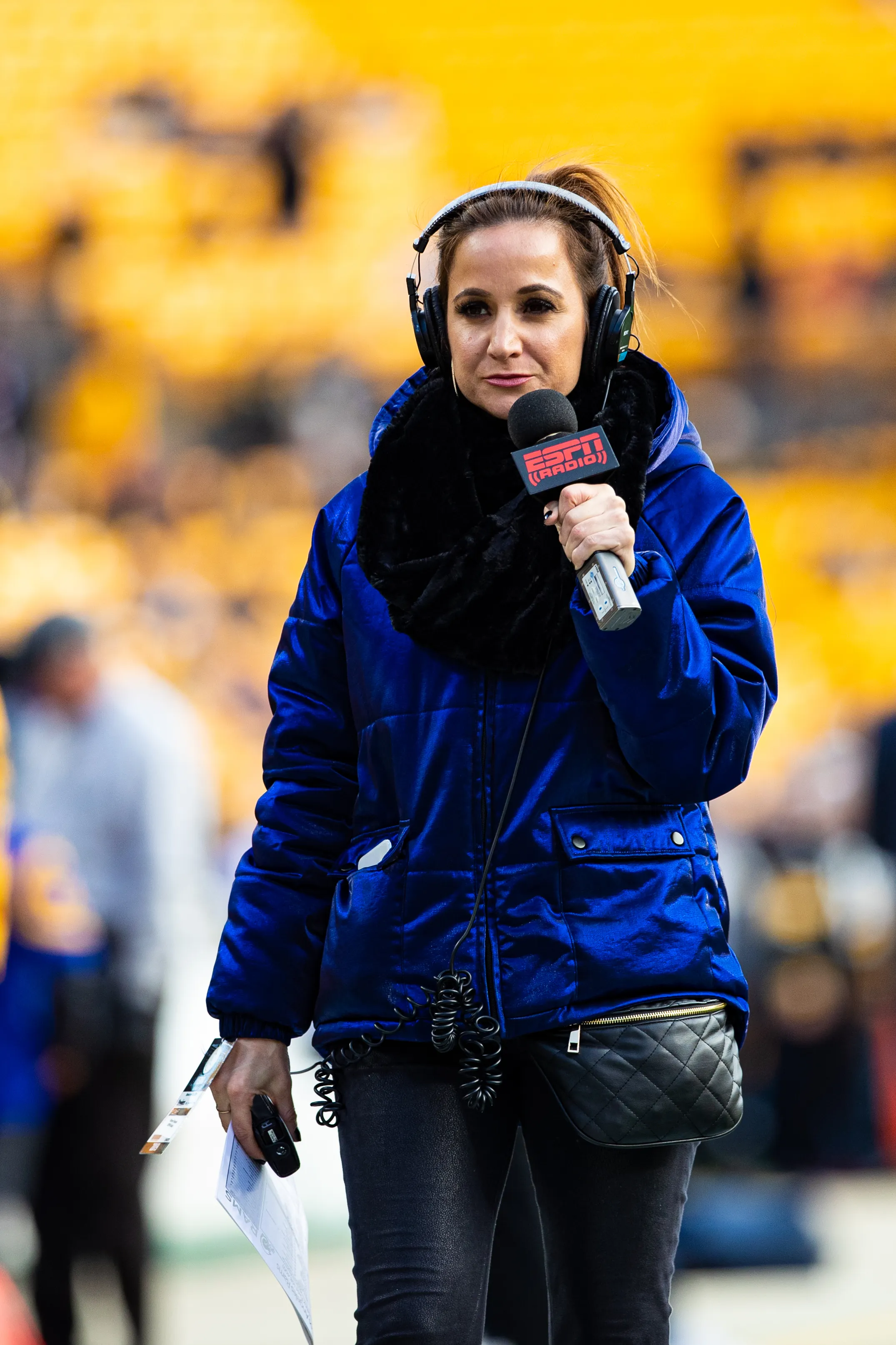Dianna Russini, an ESPN sideline reporter, holding a microphone.
