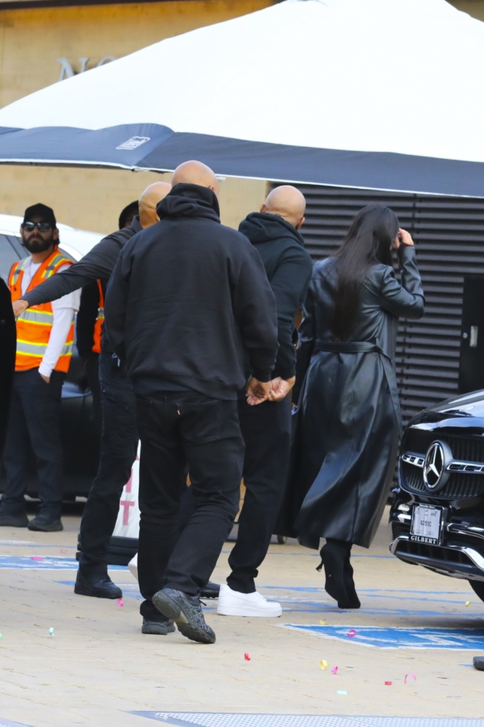 Dr. Dre, accompanied by a woman and security, leaving Nobu restaurant in Los Angeles.