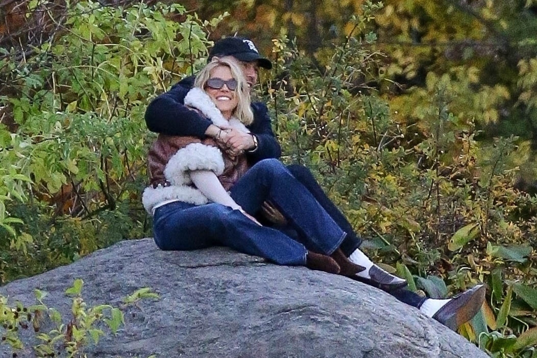 Sydney Sweeney and Scooter Braun embracing on a rock in Bryant Park.