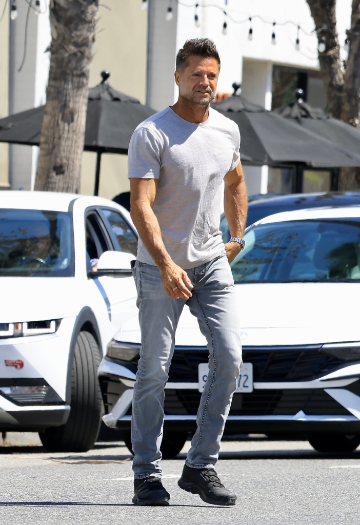 David Charvet walking down the street in a grey t-shirt and jeans.
