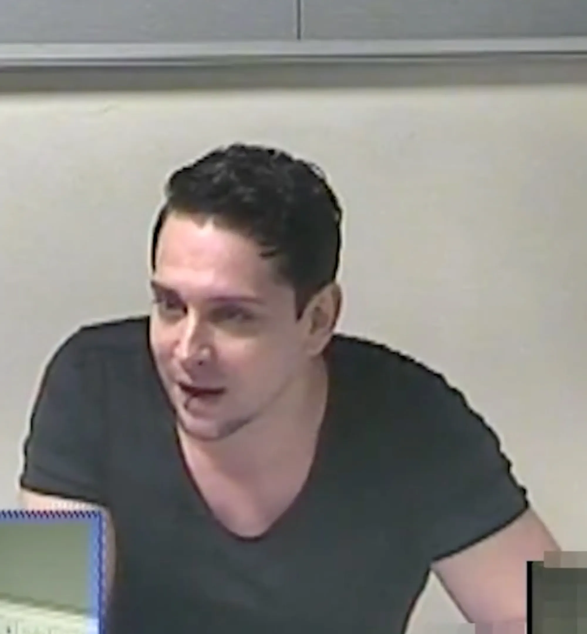 Ross Davidson smirking as he is being arrested.