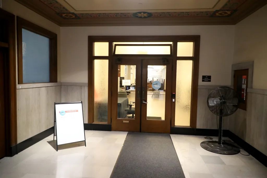 Entrance to an empty Los Angeles City Hall Finance Office with a sign indicating it's by appointment only.