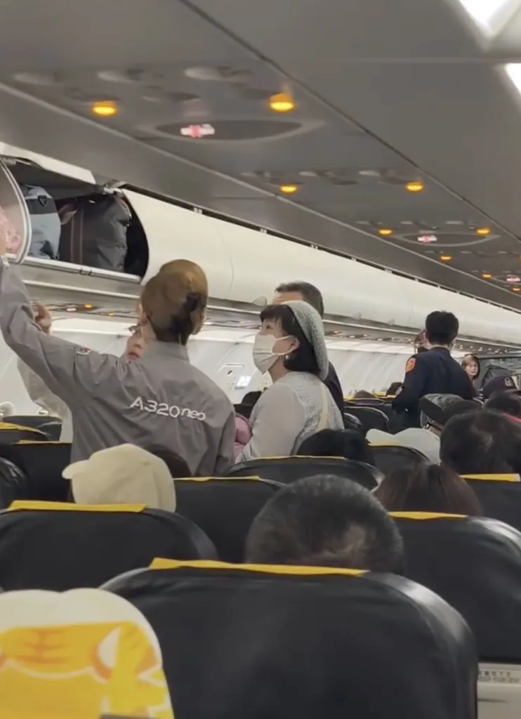 Flight attendants and authorities on a plane.