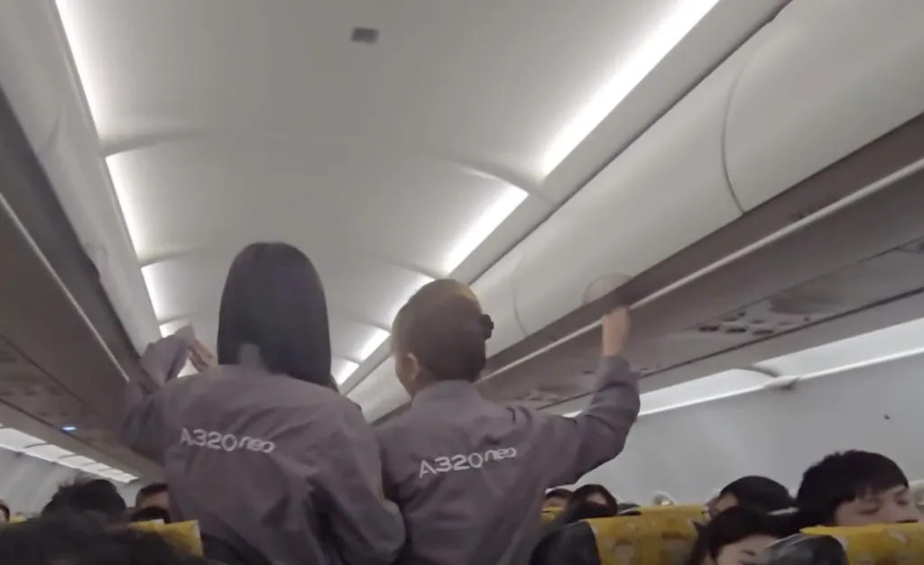 Flight attendants in aisle.