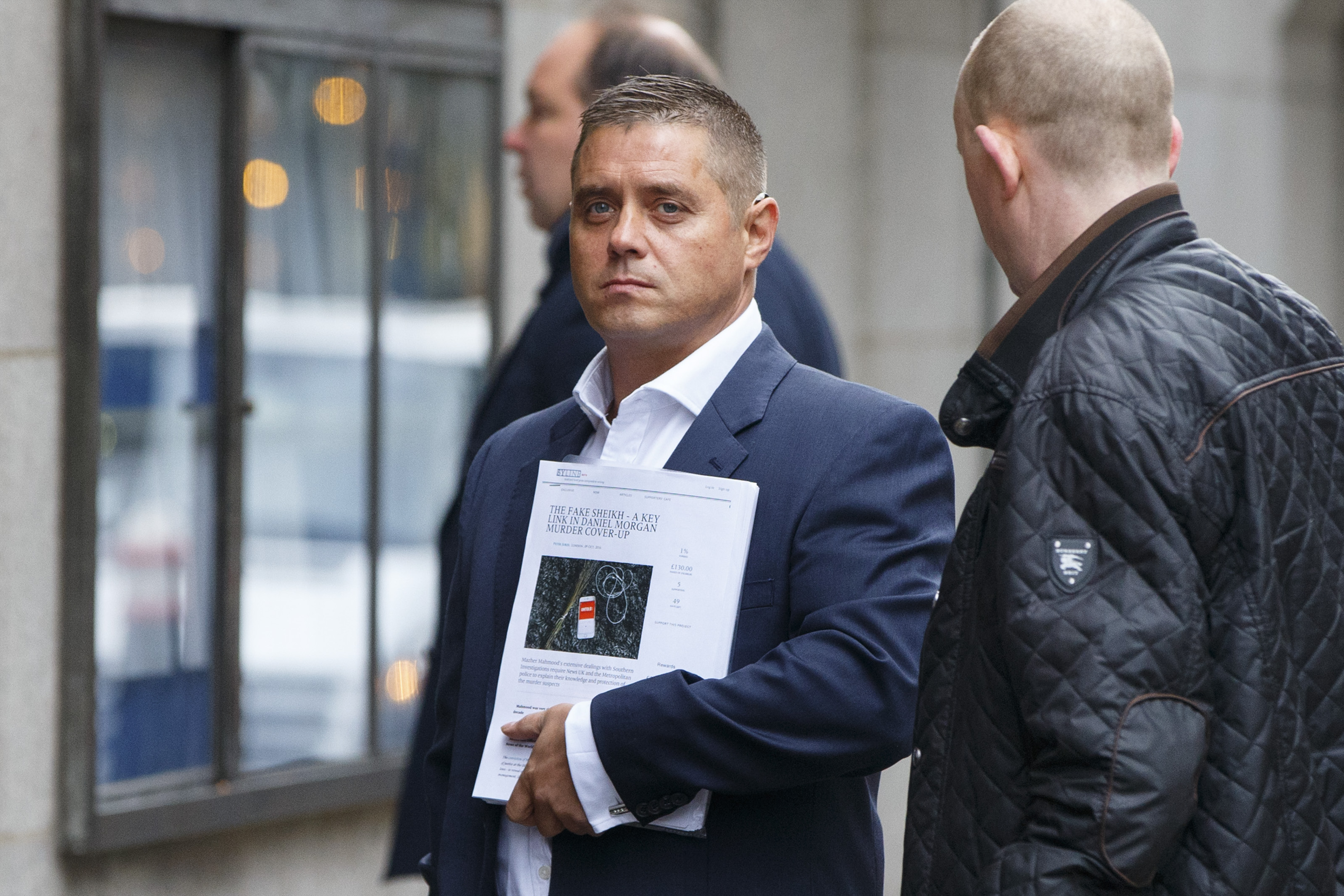 Former actor John Alford holding a document titled "The Fake Sheikh - A Key Link in Daniel Morgan Murder Cover-Up" outside the Central Criminal Court.