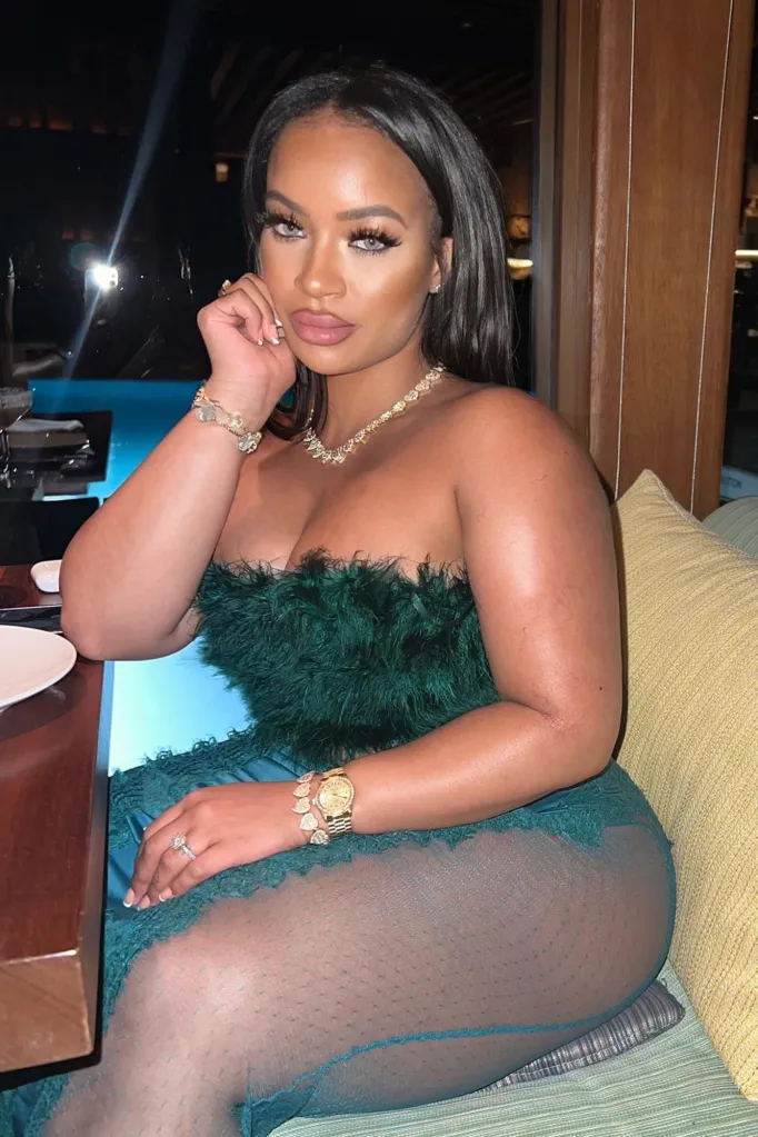 Gabrielle Carrington, known as RIELLEUK, in a teal feather-trimmed gown.
