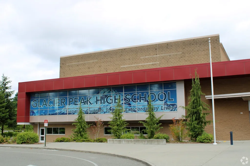 Glacier Peak High School exterior with "Welcome to Glacier Peak High School" sign on a large window.