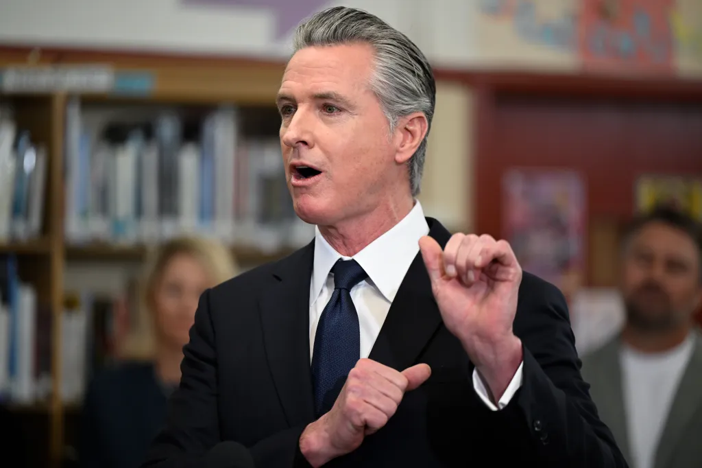 California Governor Gavin Newsom speaking at a press conference at San Lorenzo High School.