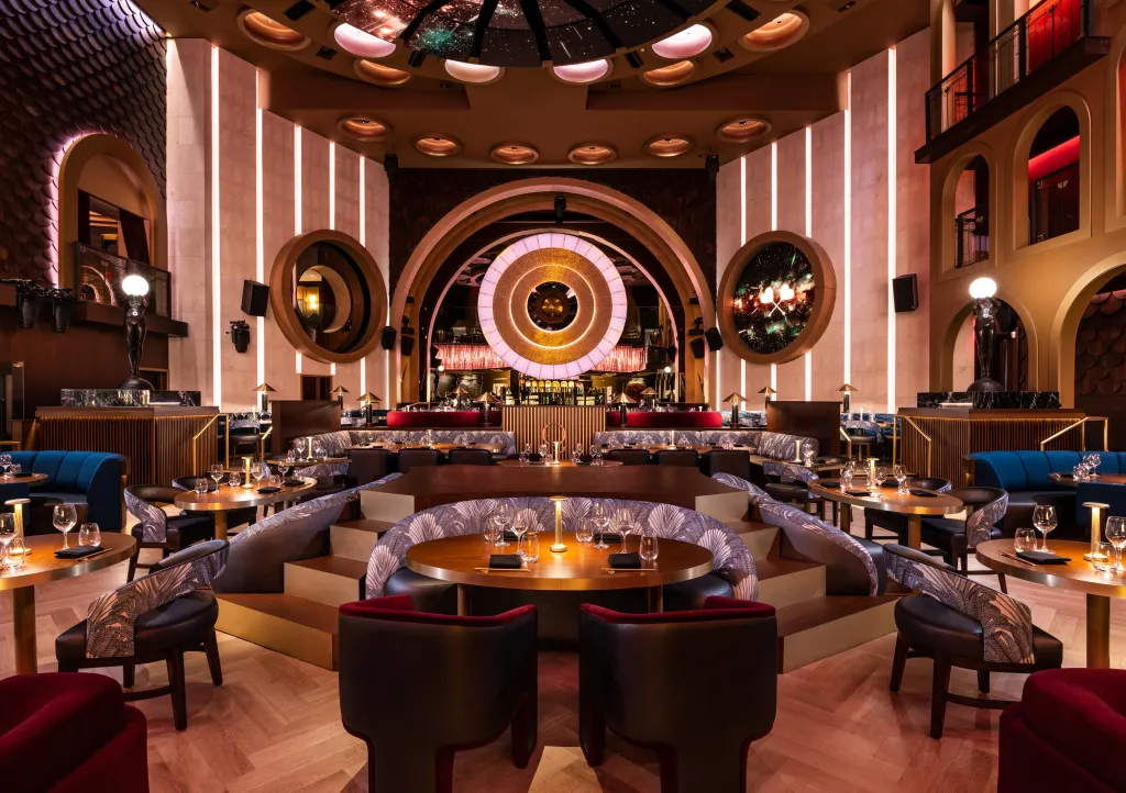 Interior of the Queen Miami Beach and Maxim Magazine Present Miami Race Nights venue with tables set for dinner.