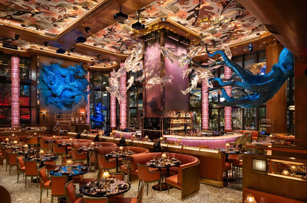 Interior of Sexy Fish restaurant with various aquatic-themed decorations including a glittery blue octopus and fish sculptures.