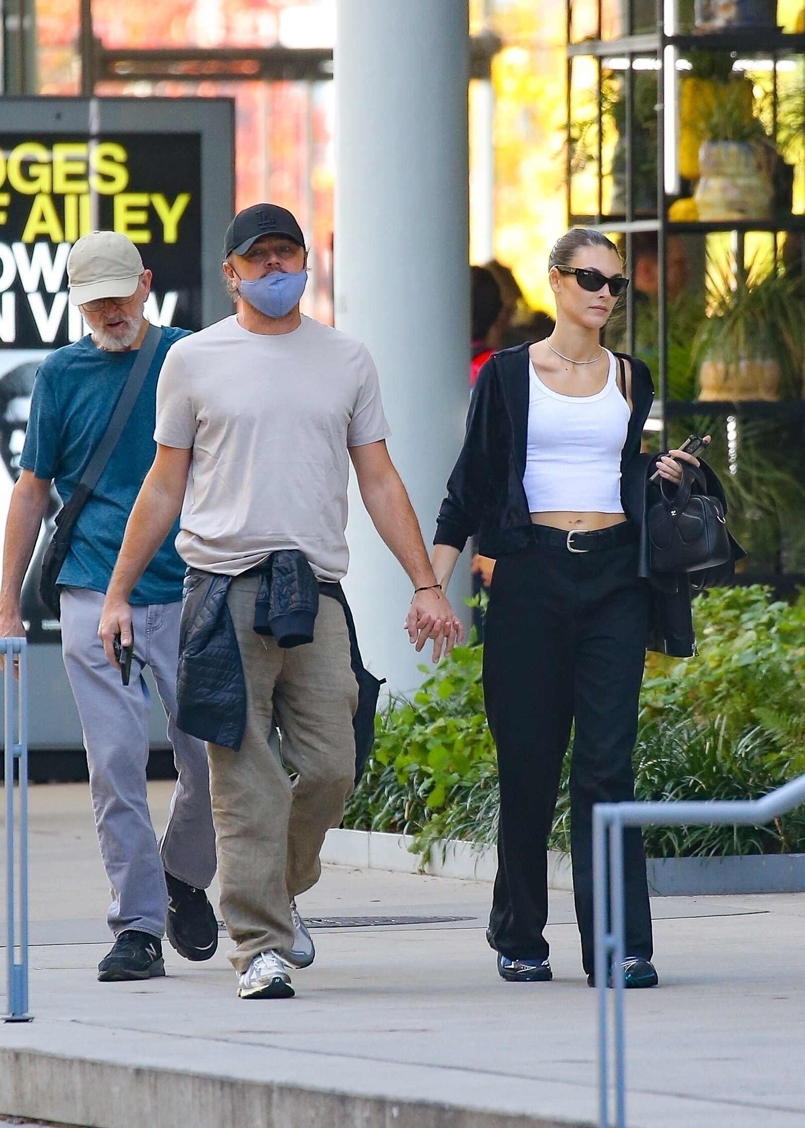 Leonardo DiCaprio and Vittoria Ceretti holding hands during a stroll in NYC.