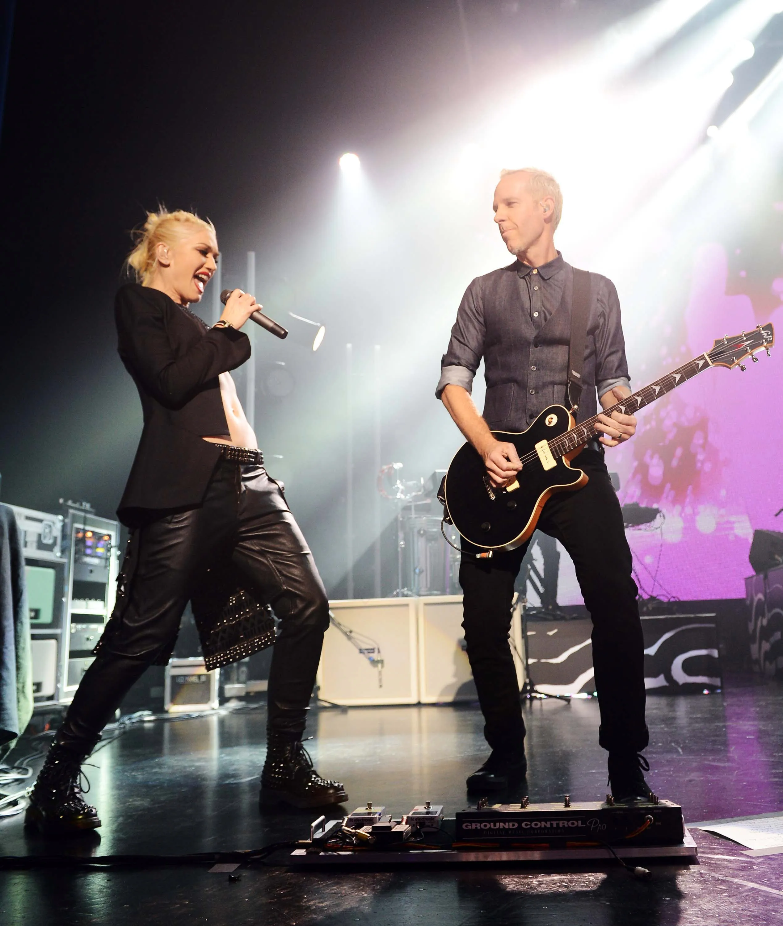 Gwen Stefani and Tom Dumont performing on stage.