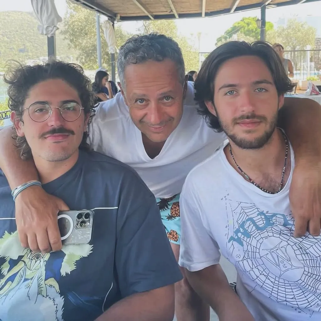 Omer Shem Tov (right), who was kidnapped by Hamas, with two men.