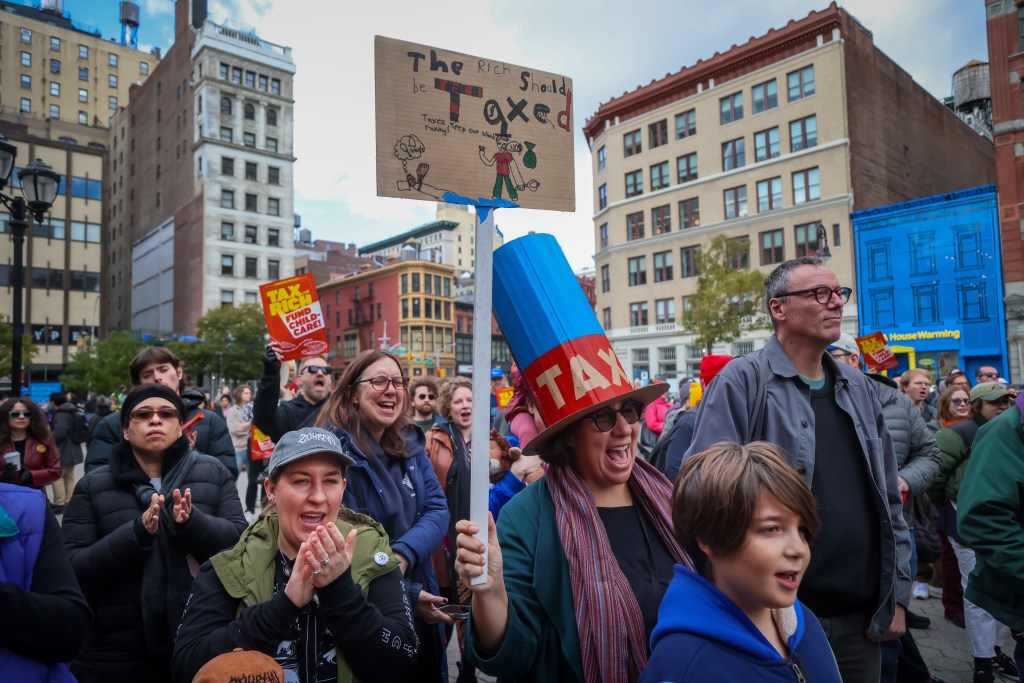 People rally in NYC to "Tax the Rich" and "Fund Child-Care!" as part of a campaign led by the NYC Democratic Socialists.