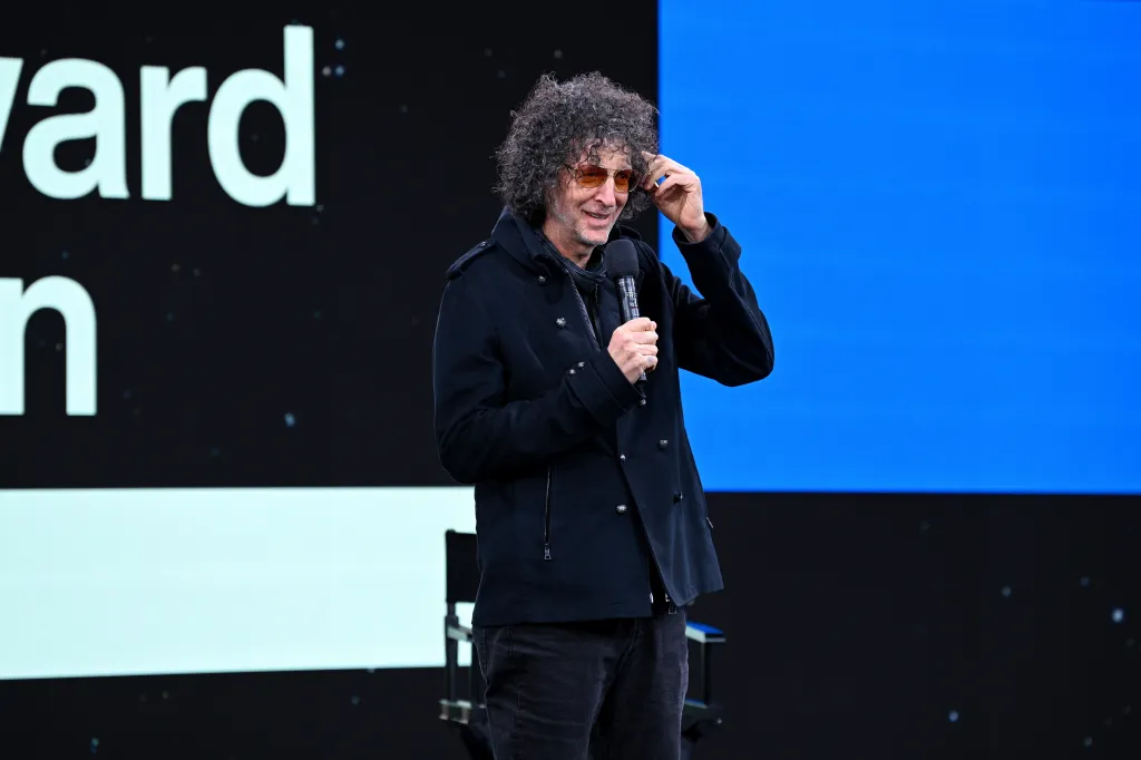Howard Stern speaking on stage at SiriusXM Next Generation event.