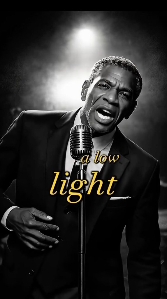 Illustration of a man in a suit singing into a microphone, with the words "a low light" in yellow over his chest.