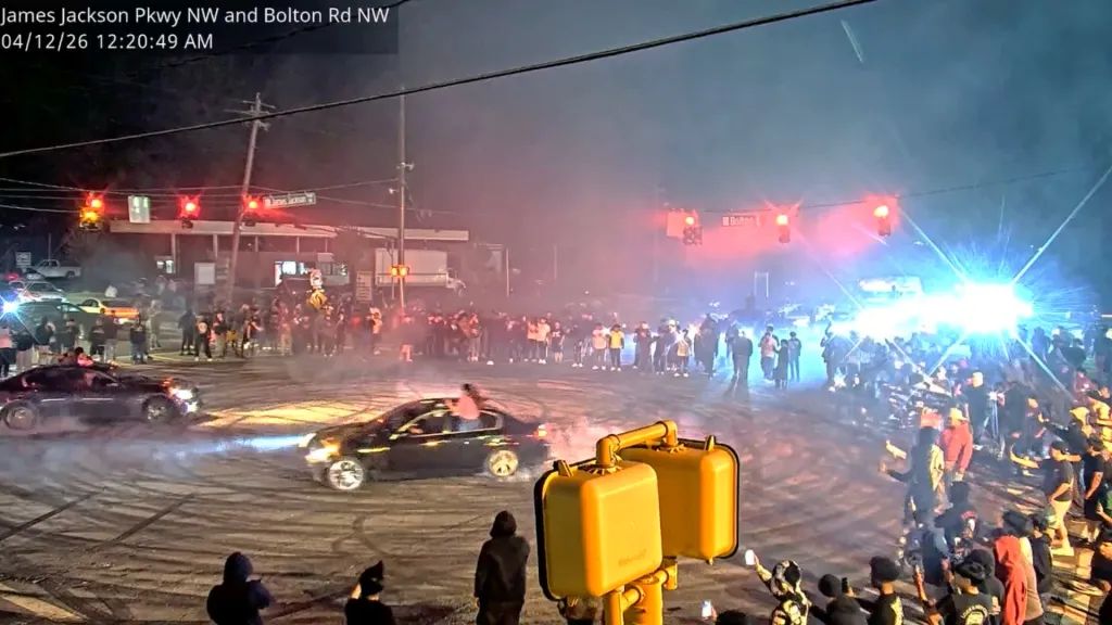 Hundreds of people swarm an Atlanta intersection to perform illegal street racing "donuts."