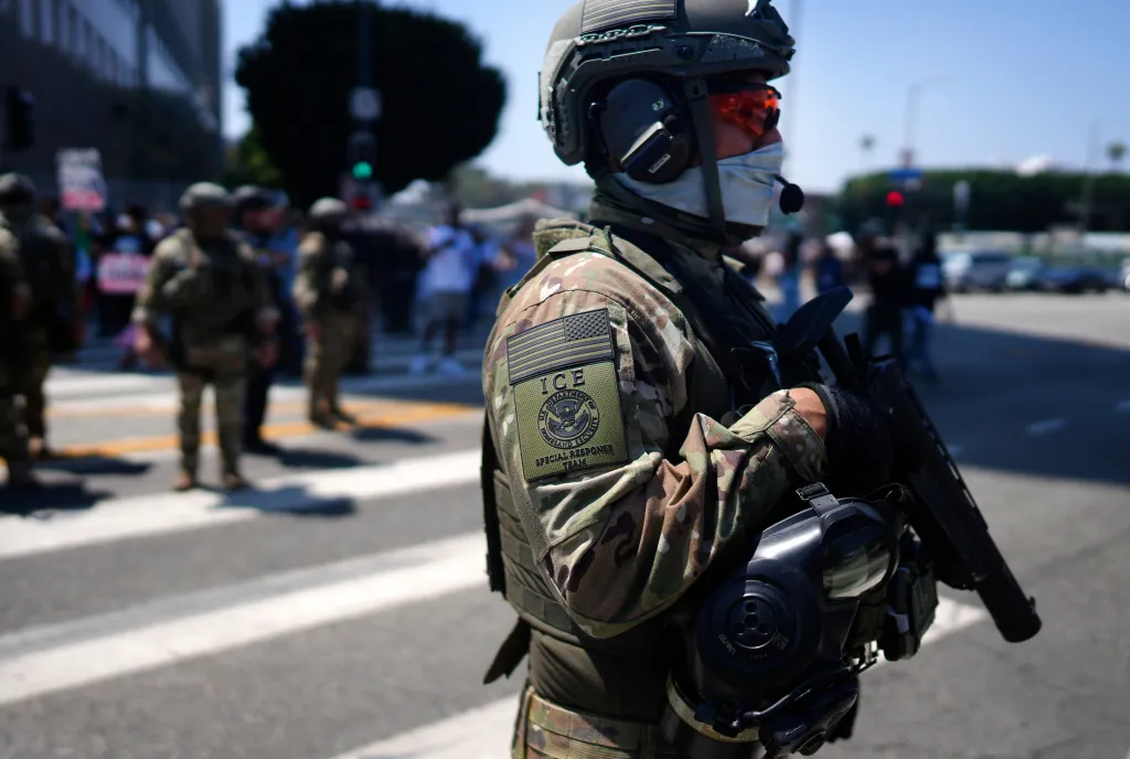 ICE Special Response Team member stands guard outside the Metropolitan Detention Center.