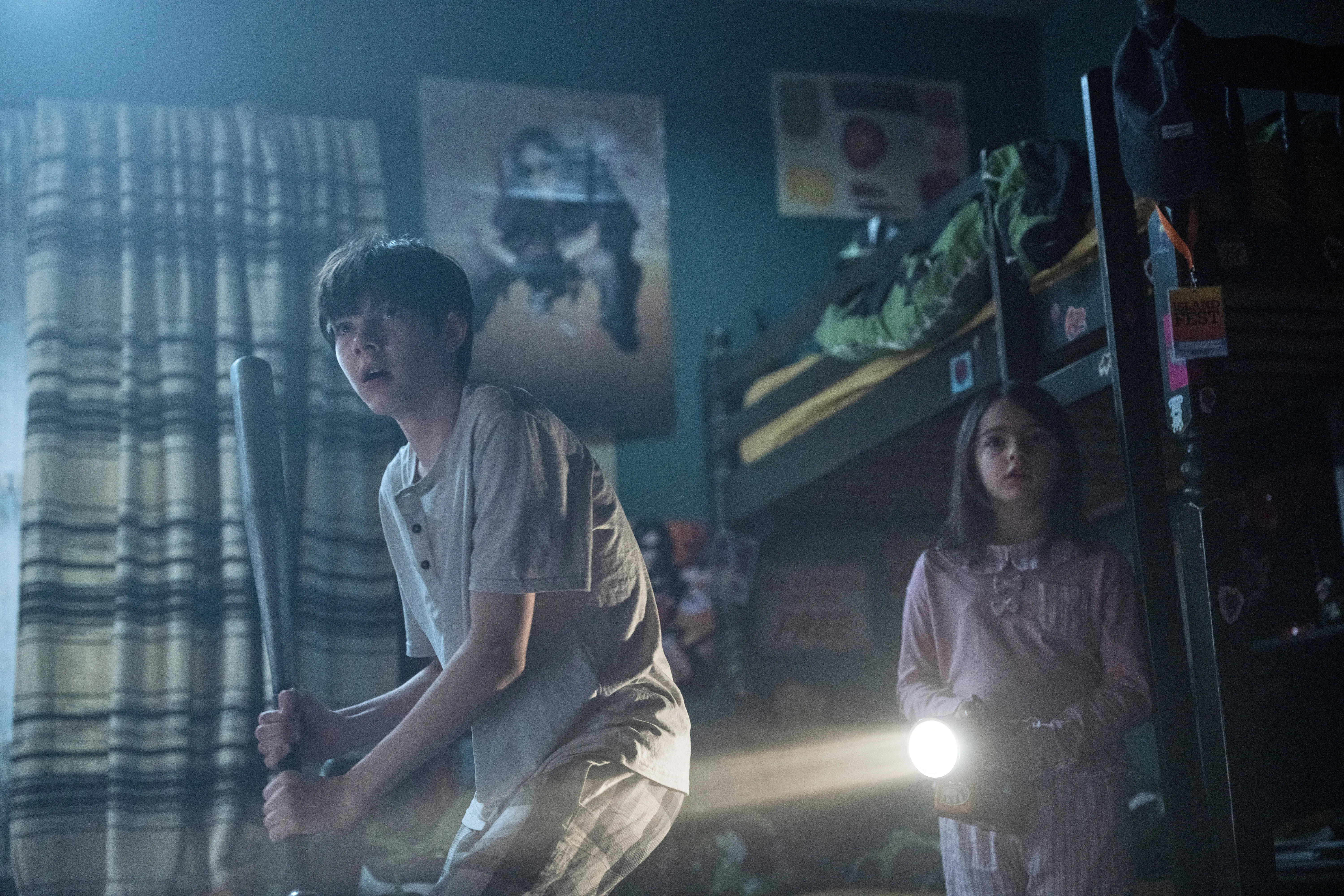 Shylo Molina holding a baseball bat and Billie Roy holding a flashlight in a scene from 