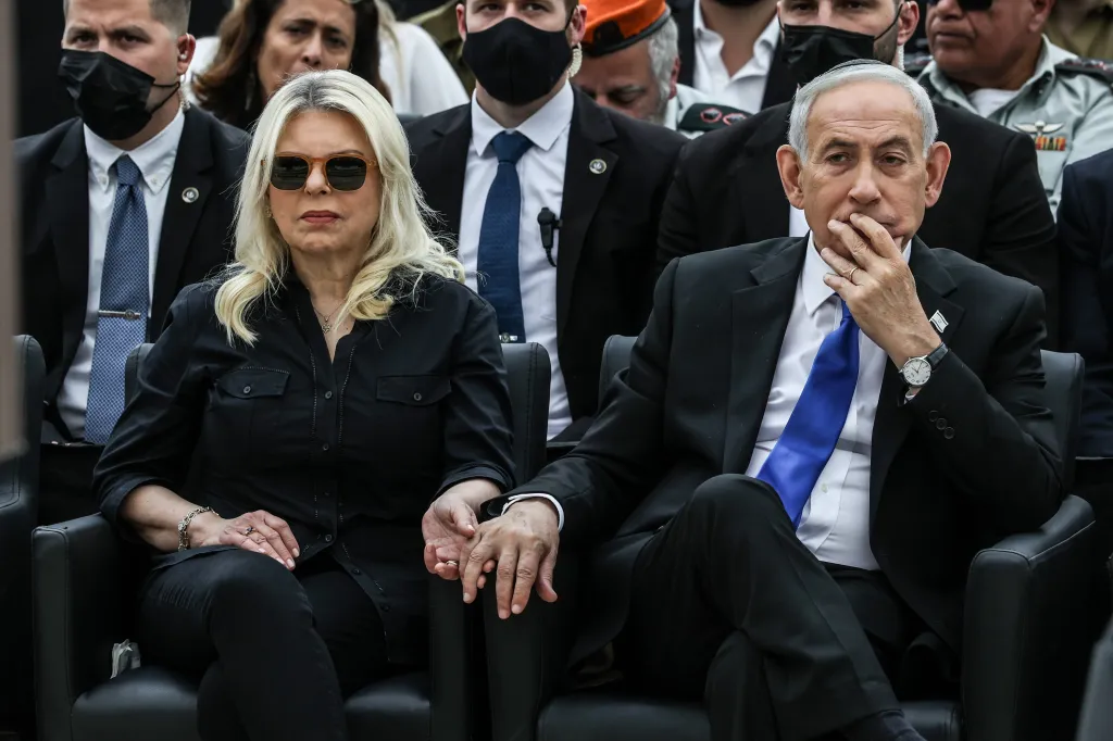Israeli Prime Minister Benjamin Netanyahu and his wife Sara hold hands during a Remembrance Day ceremony.
