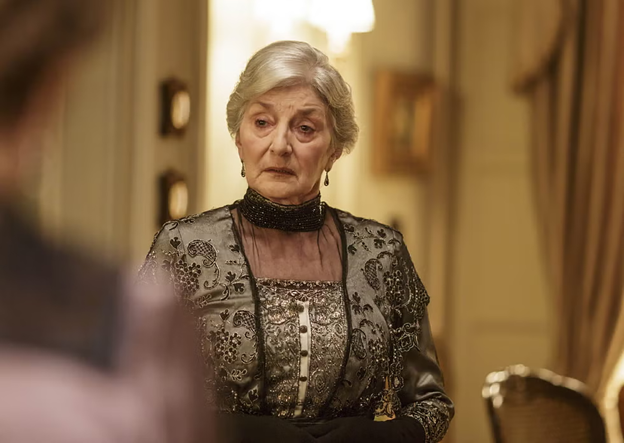 Jane Lapotaire in Downton Abbey, looking off to her right with a serious expression.