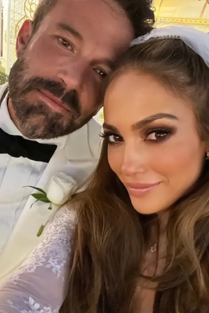 Jennifer Lopez and Ben Affleck taking a selfie at their wedding.