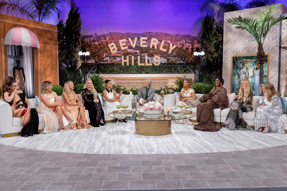 A group of eleven women and one man sitting on white couches for The Real Housewives of Beverly Hills reunion show.