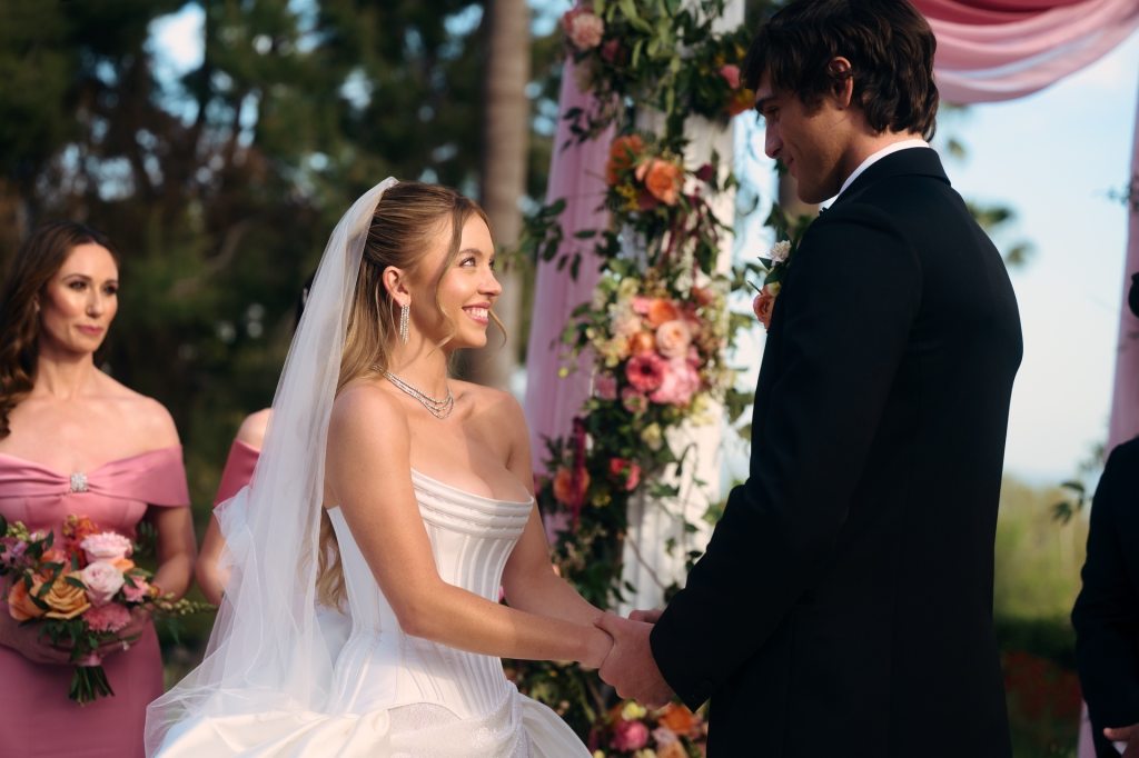 Sydney Sweeney as Cassie and Jacob Elordi as Nate at their wedding with Jessica Blair Herman as Cassie's mom.