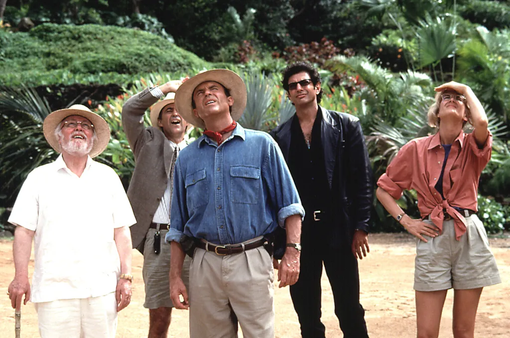 Richard Attenborough, Martin Ferrero, Sam Neill, Jeff Goldblum, and Laura Dern looking up at an unseen dinosaur in "Jurassic Park."