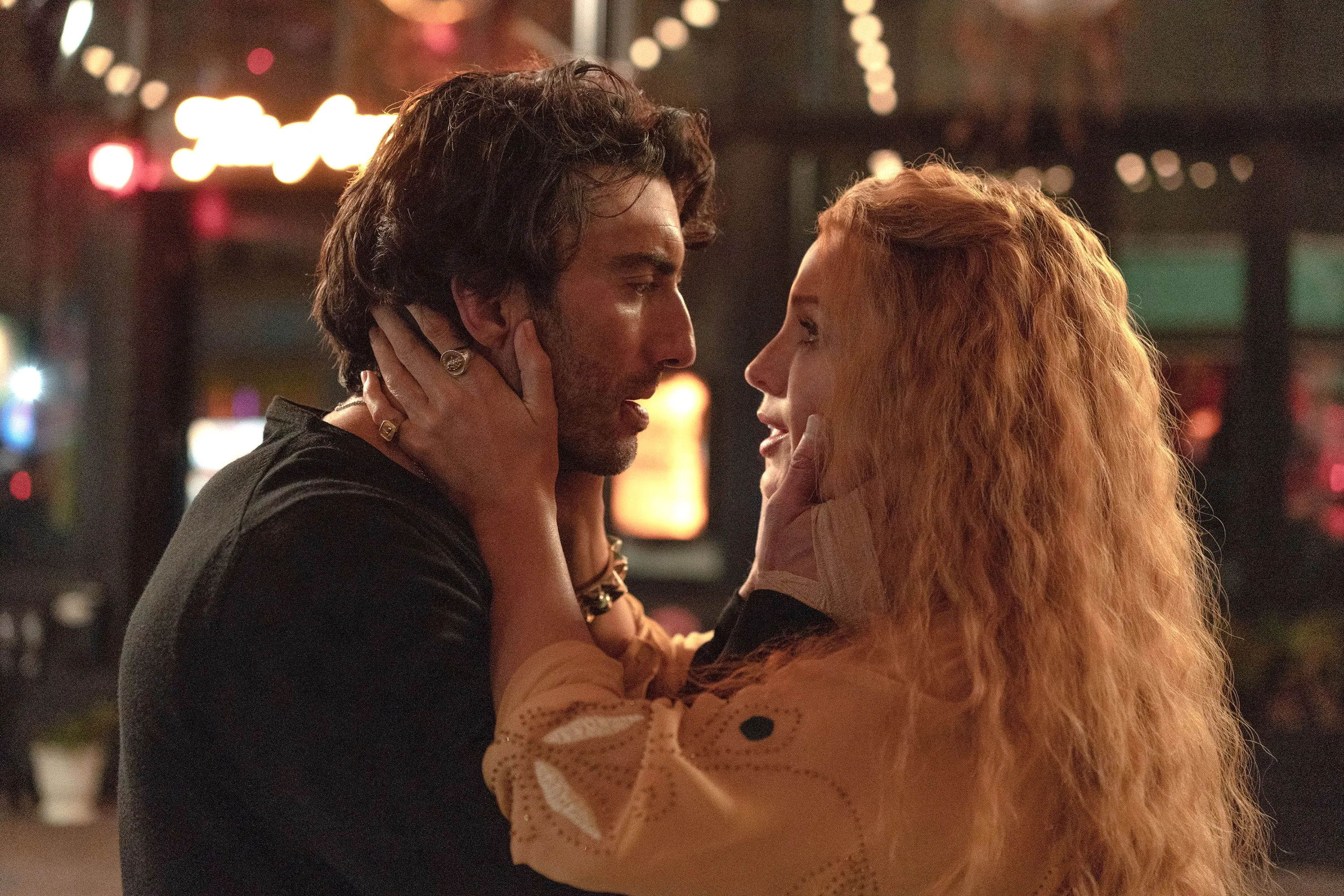 Justin Baldoni and Blake Lively look intently at each other.