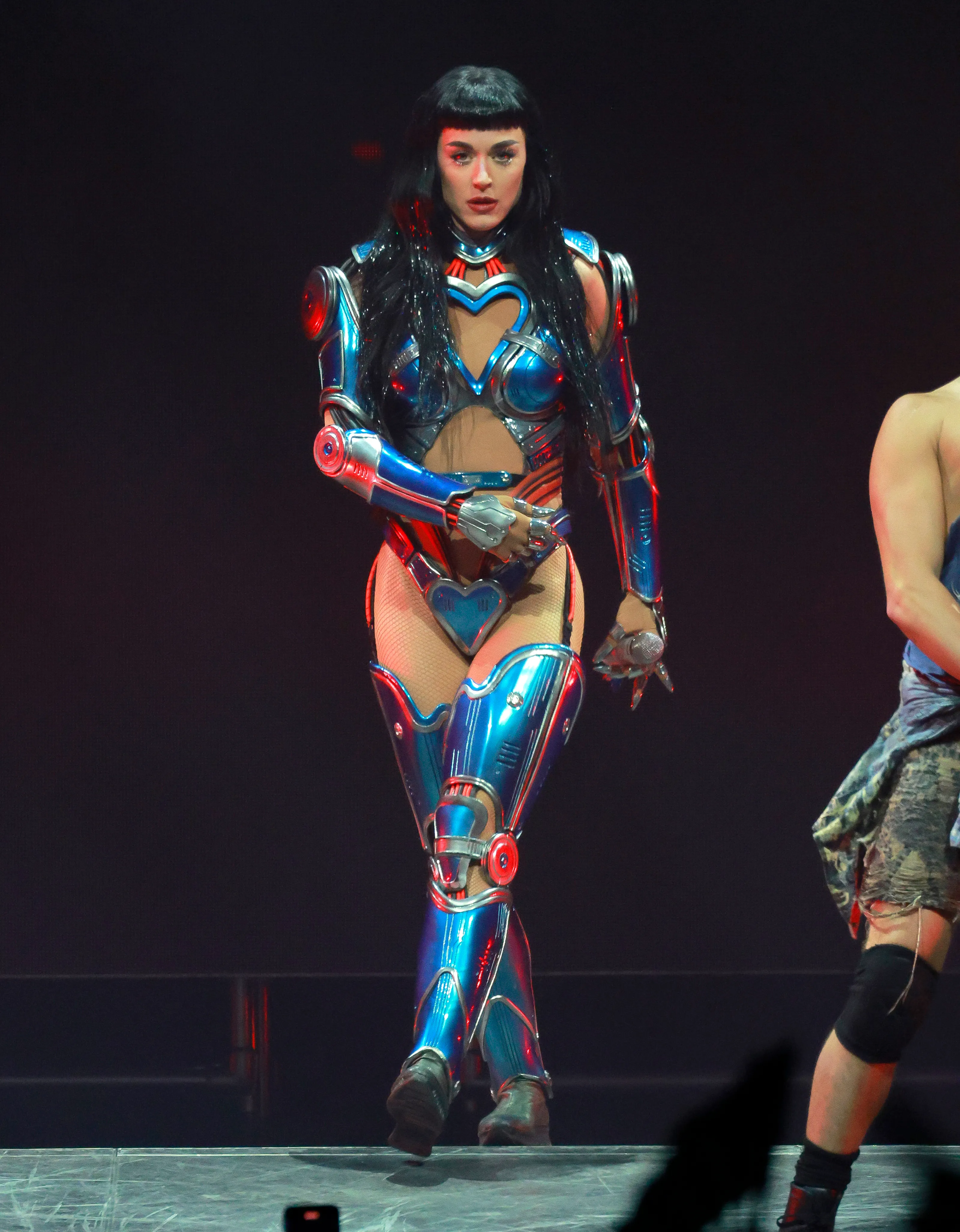 Katy Perry performing in a blue and silver robotic-inspired costume.