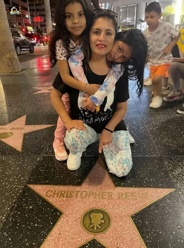 Khimberly Zavaleta and her family posing on the Hollywood Walk of Fame.