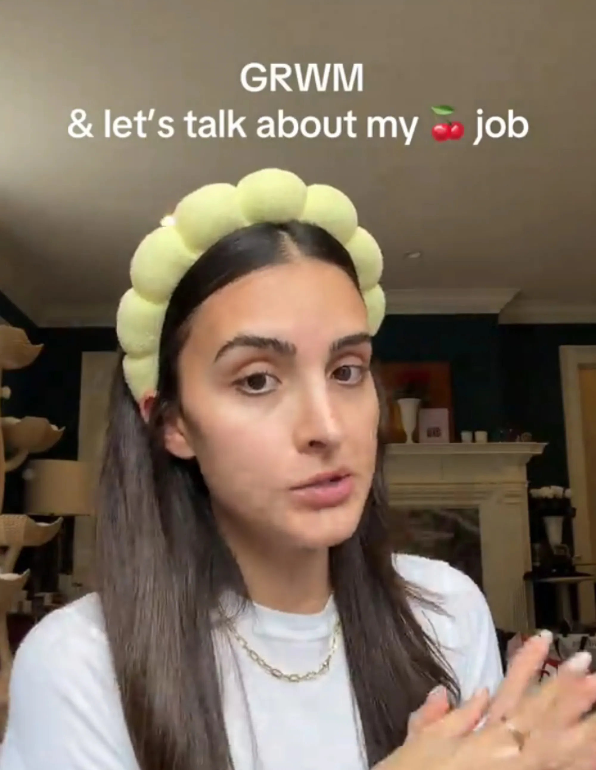 Sophia Umansky, a young woman with long dark hair and a yellow padded headband, gestures with her hands as text overlaid on the video reads 