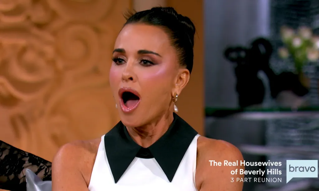 Kyle Richards with her mouth open, surprised or speaking, at a reunion for The Real Housewives of Beverly Hills.