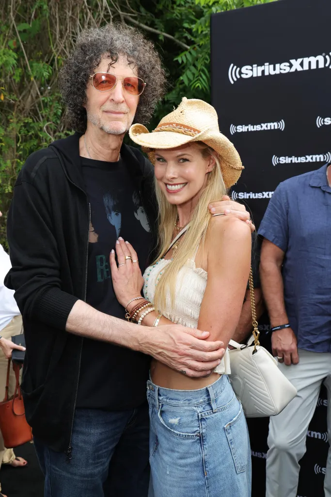 Howard and Beth Stern stand together in front of a SiriusXM backdrop.