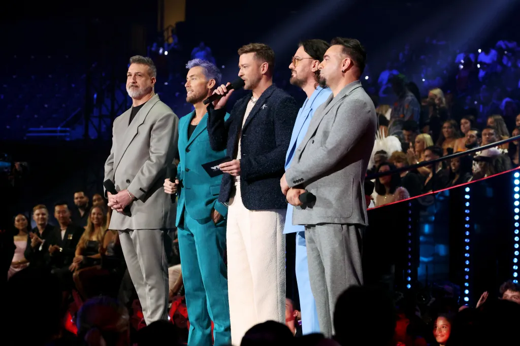 NSYNC members Joey Fatone, Lance Bass, Justin Timberlake, JC Chasez, and Chris Kirkpatrick speaking onstage at the 2023 MTV Video Music Awards.