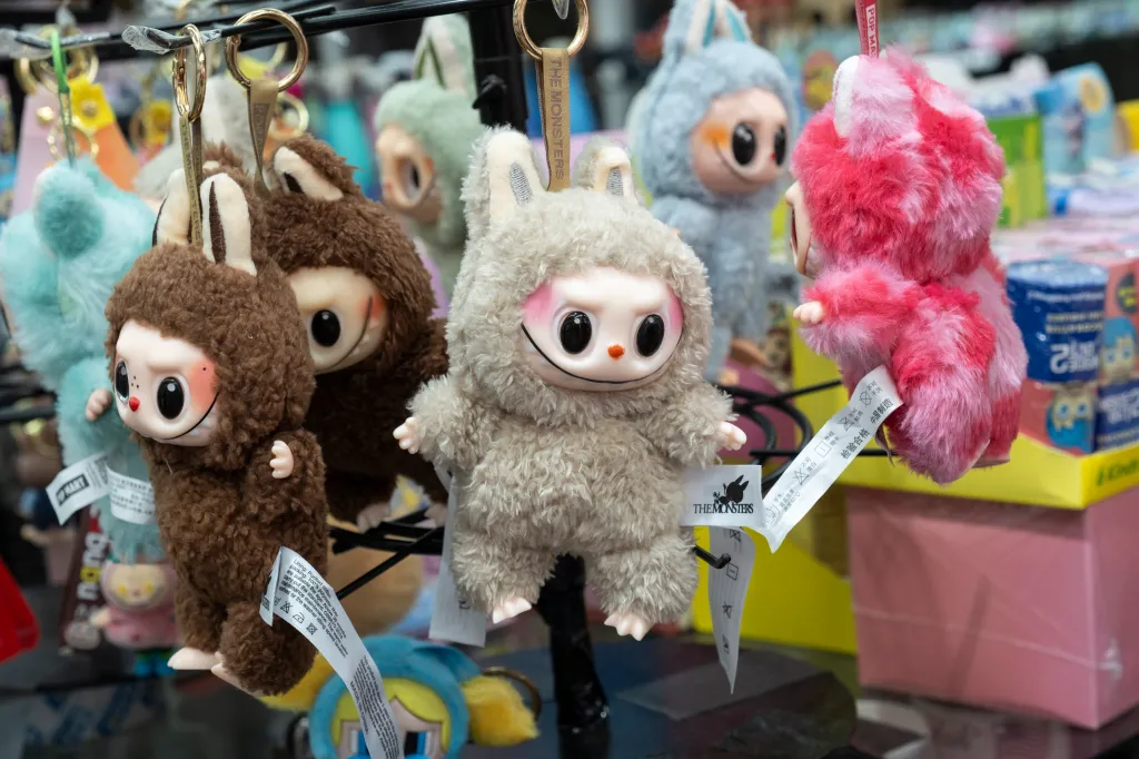 Multiple Labubu dolls on display with attached tags reading "THE MONSTERS" and "MADE IN CHINA".