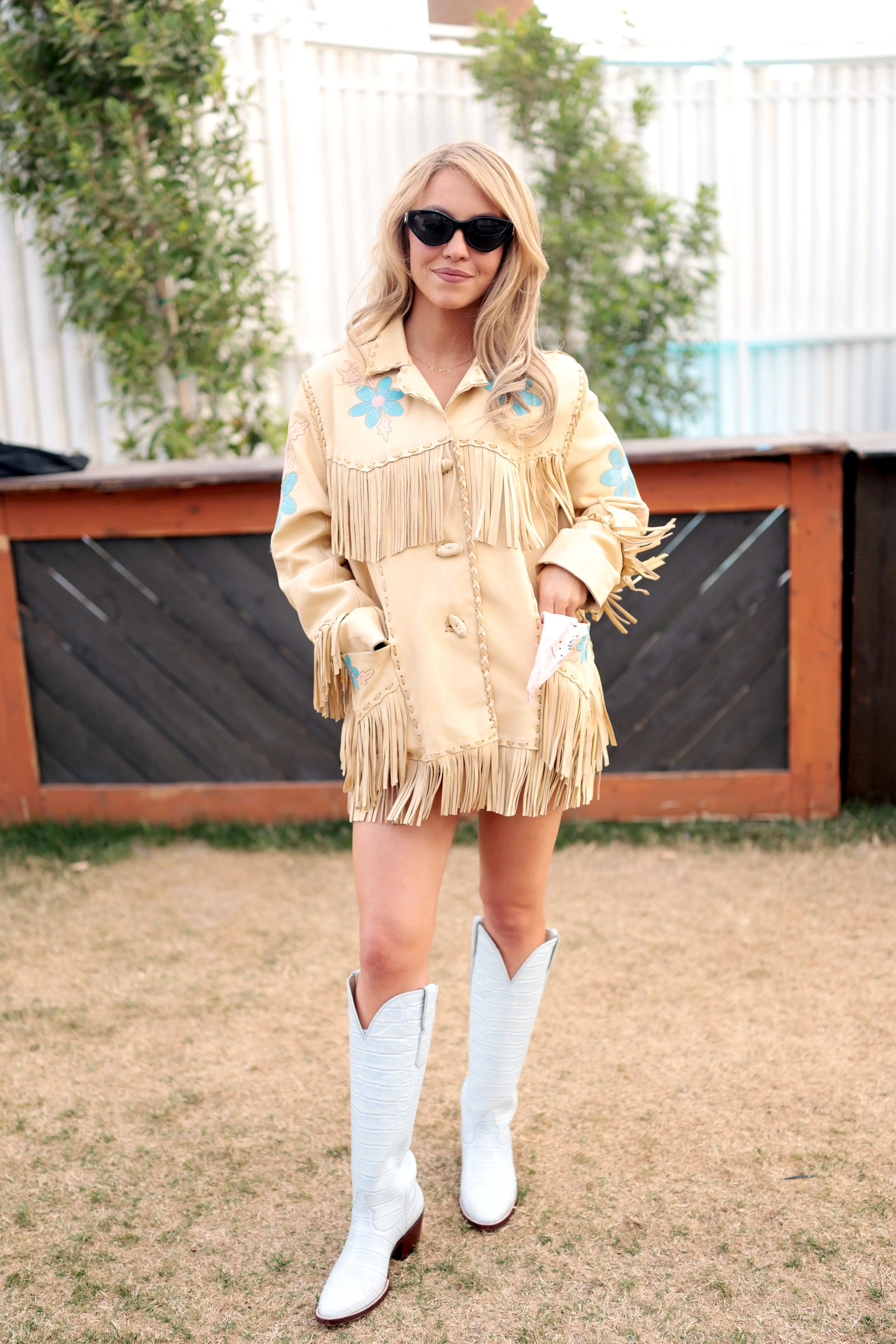 Sydney Sweeney posing for a portrait backstage during the 2026 Stagecoach Festival.