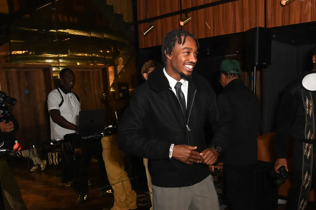Lil Tjay smiling at the premiere of his film.
