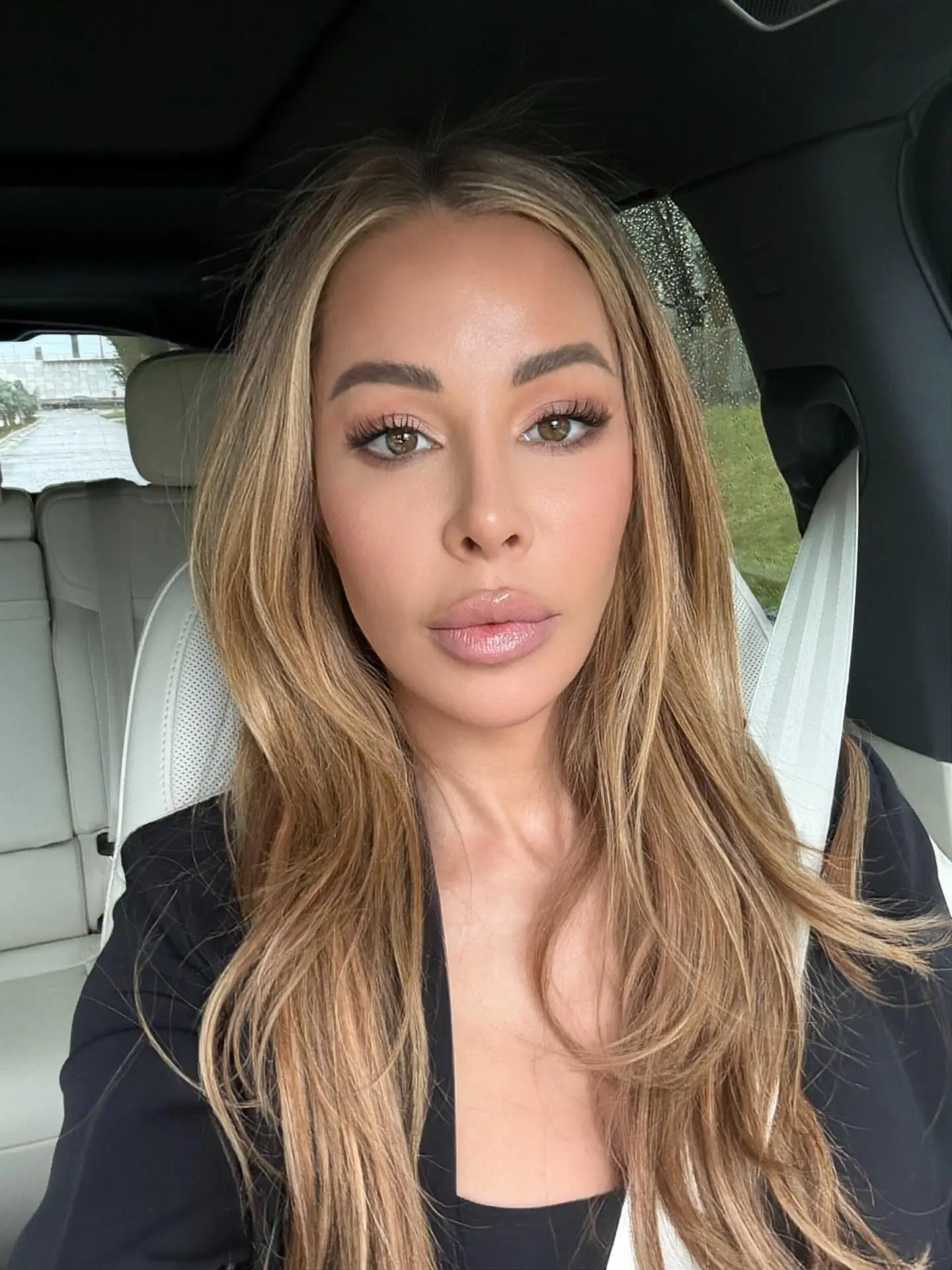 Lisa Hochstein posing for a selfie in a car.