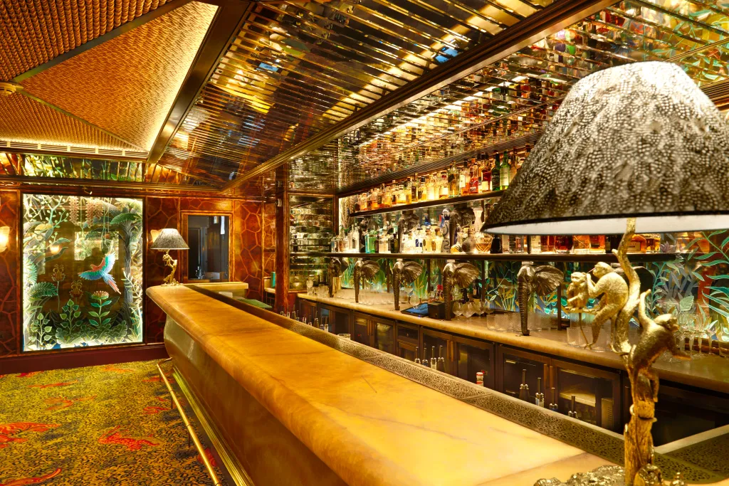 The Jungle Bar at Annabel's Nightclub, with bottles of alcohol, jungle-themed decor, and monkey and elephant figures.