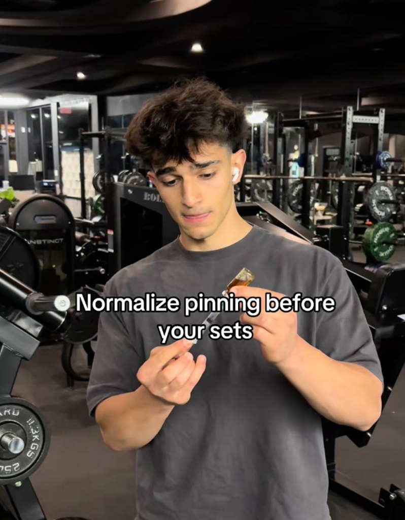 A man in a gym holding a vial and needle with text overlay "Normalize pinning before your sets."