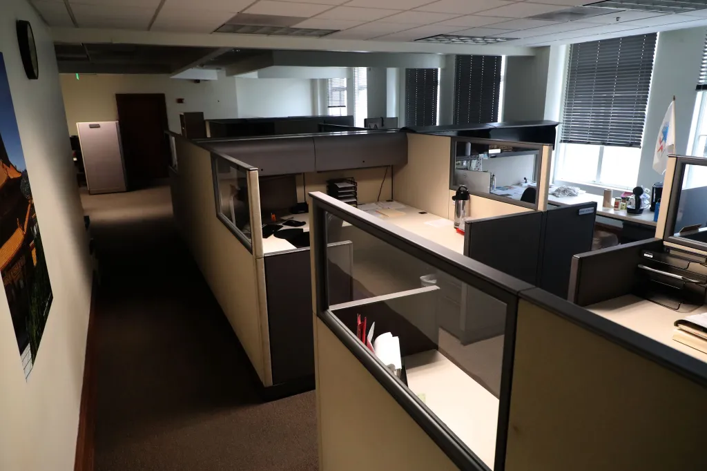 Empty office cubicles in Los Angeles City Hall after many workers transitioned to remote work.