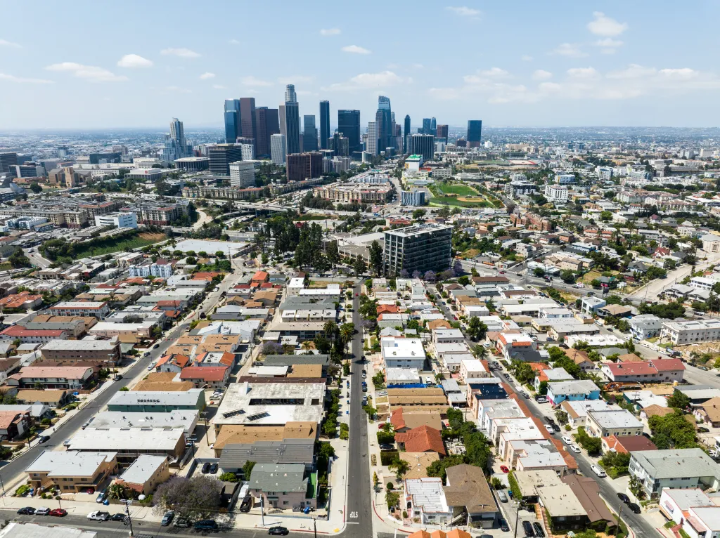 Aerial view of Los Angeles skyline from a residential neighborhood.
