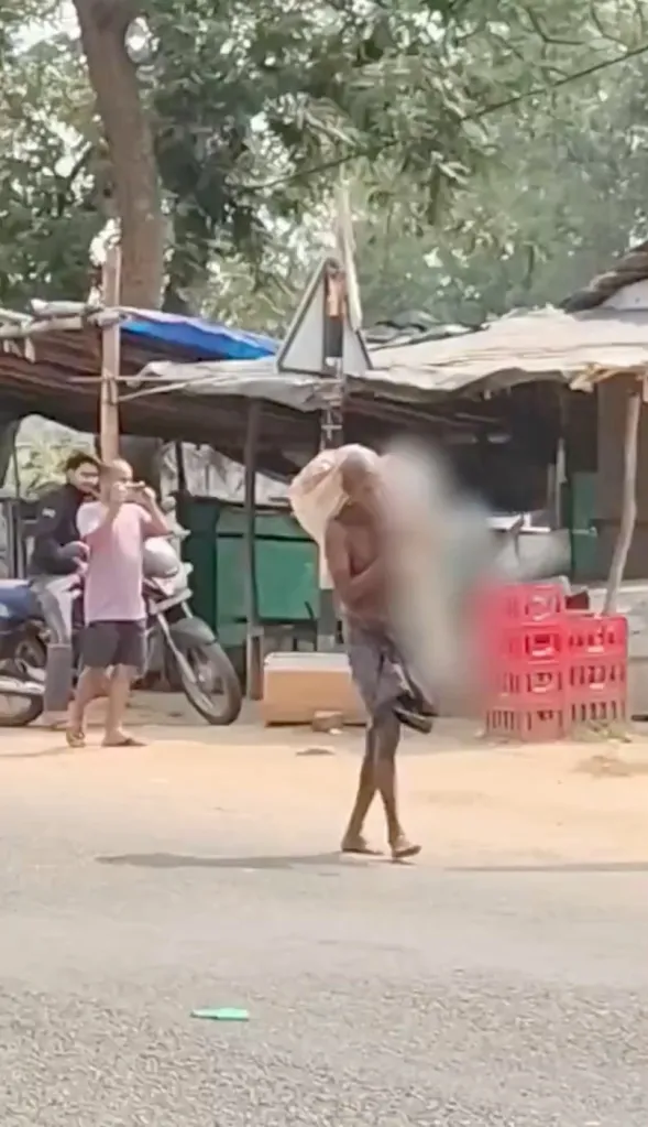 A man carrying his deceased sister's skeleton to a bank in India.