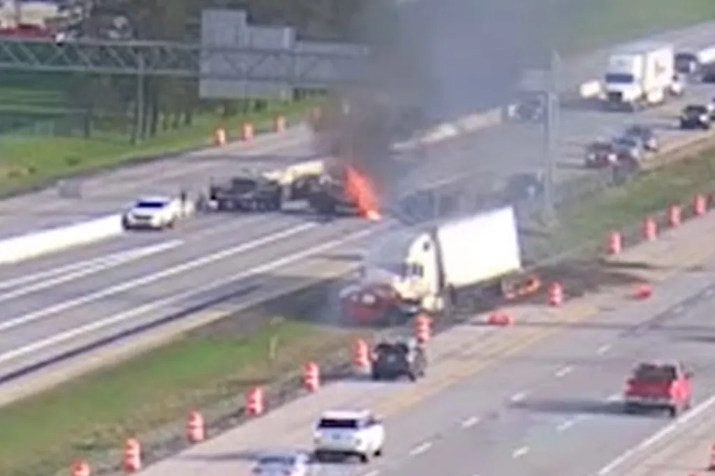 Overhead view of a multi-car accident on a highway, with a truck and several cars on fire.