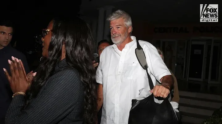 Brian Hooker carrying a black bag, released from custody in the Bahamas.
